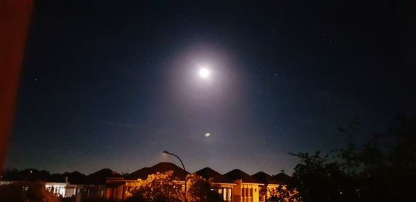 Low angle view of illuminated building against sky at night