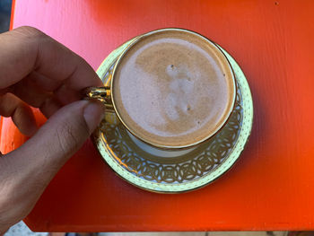 Hand holding coffee cup