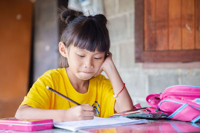 Portrait of a girl sitting on table