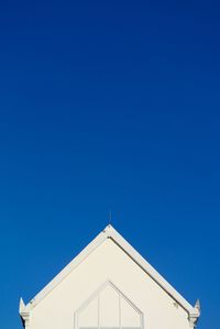 High section of building against clear blue sky