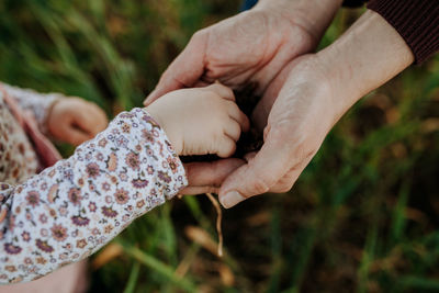 Close-up of couple holding hands