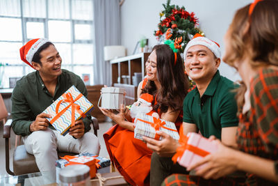 Female friends using smart phone while sitting at restaurant