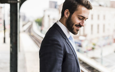 Young businessman waiting at metro station platform