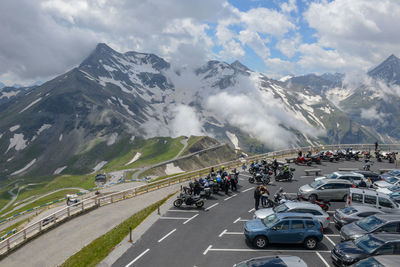 Traffic on road in mountains against sky