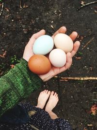 Low section of woman standing with vegetables