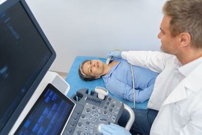 Young man using laptop at clinic