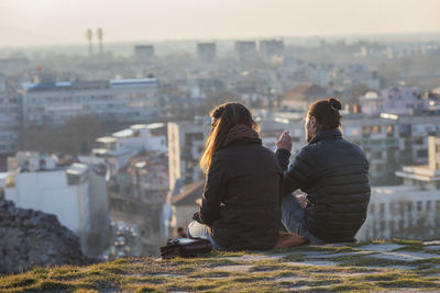 Rear view of couple looking at cityscape