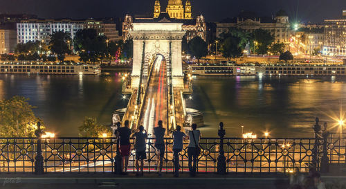 Bridge over river in city at night