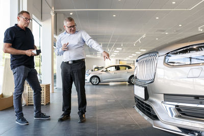 Men in car showroom