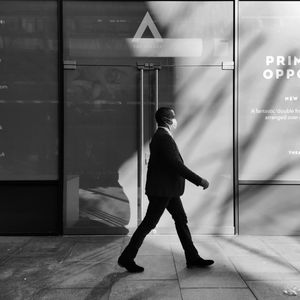 Side view of a man walking on floor