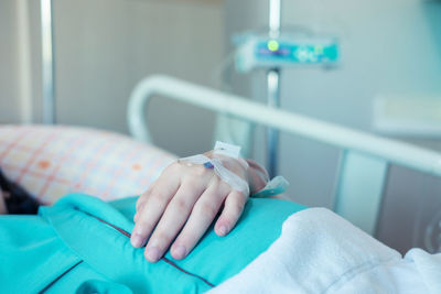Close-up of person lying on bed