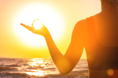 Low angle view of silhouette woman against sky during sunset