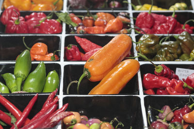 Spicy chili peppers of various colors, sold at market