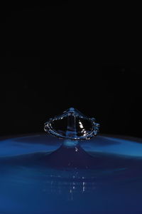 Close-up of water drop against black background