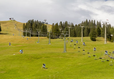 Scenic view of trees on field against sky