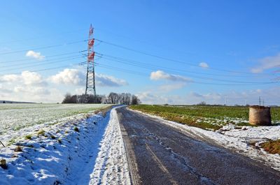 Low angle view of electricity pylon against sky