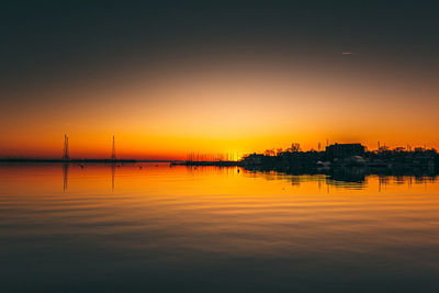 Scenic view of lake against romantic sky at sunset