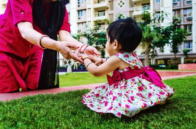 Midsection of woman playing with daughter in park