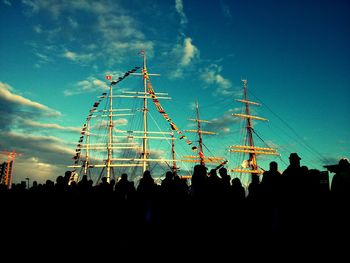 Low angle view of silhouette people against sky