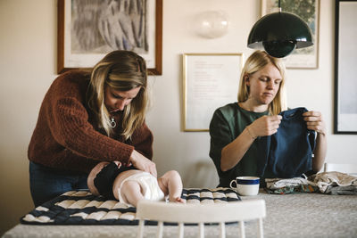 Mothers taking care of newborn baby at home