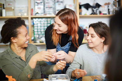 Cheerful multi-ethnic female engineers at workshop