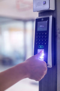 Cropped hand using mobile phone