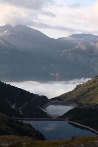 Scenic view of lake and mountains against sky