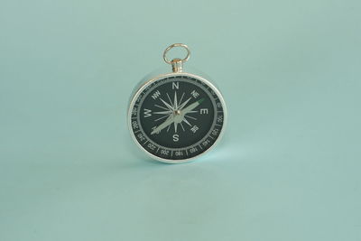 Close-up of wristwatch against blue background