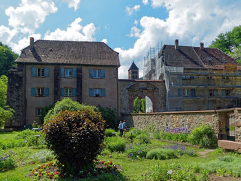 Panoramic shot of building by plants against sky