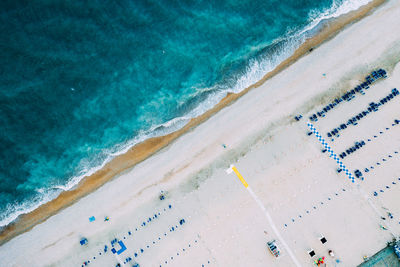 Top view of natural clear blue sea and white sand beach with umbrella