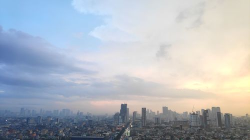 Cityscape against sky during sunset