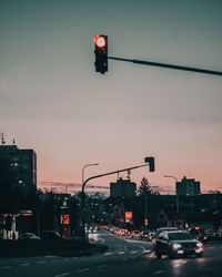 Traffic on road at sunset