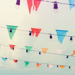 Low angle view of flags hanging against sky