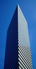 Low angle view of modern building against clear blue sky