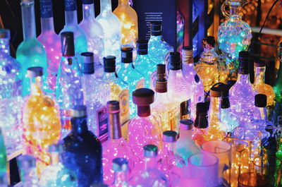 Close-up of multi colored bottles on display at store