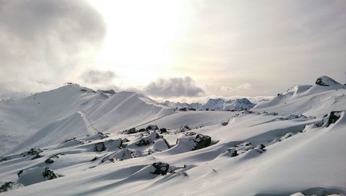 Tourists on snow covered mountain