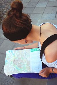 High angle view of young woman looking at map