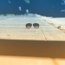 Close-up of sunglasses on sidewalk.