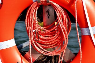 Close-up of multi colored rope tied to metal
