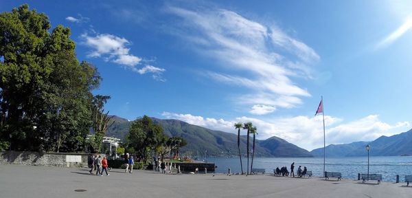 Panoramic view of people on mountain against sky