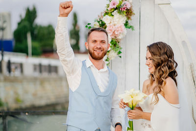 Young couple holding flower bouquet