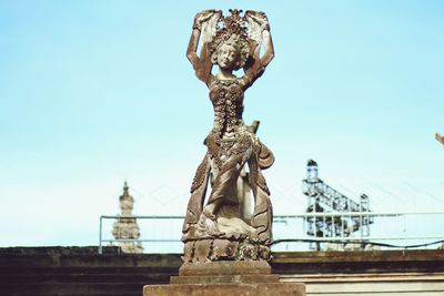 Low angle view of statue against sky