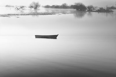 Boat in lake against trees