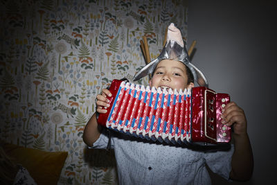 Smiling boy playing accordion