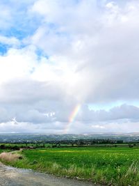 Scenic view of rainbow over field