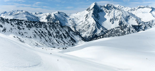 Scenic view of snow covered mountains against sky