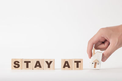 Midsection of person holding toy against white background