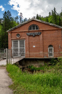 Built structure on field by building against sky