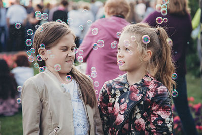 Portrait of girl looking at bubbles