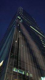 Low angle view of illuminated building against sky at night